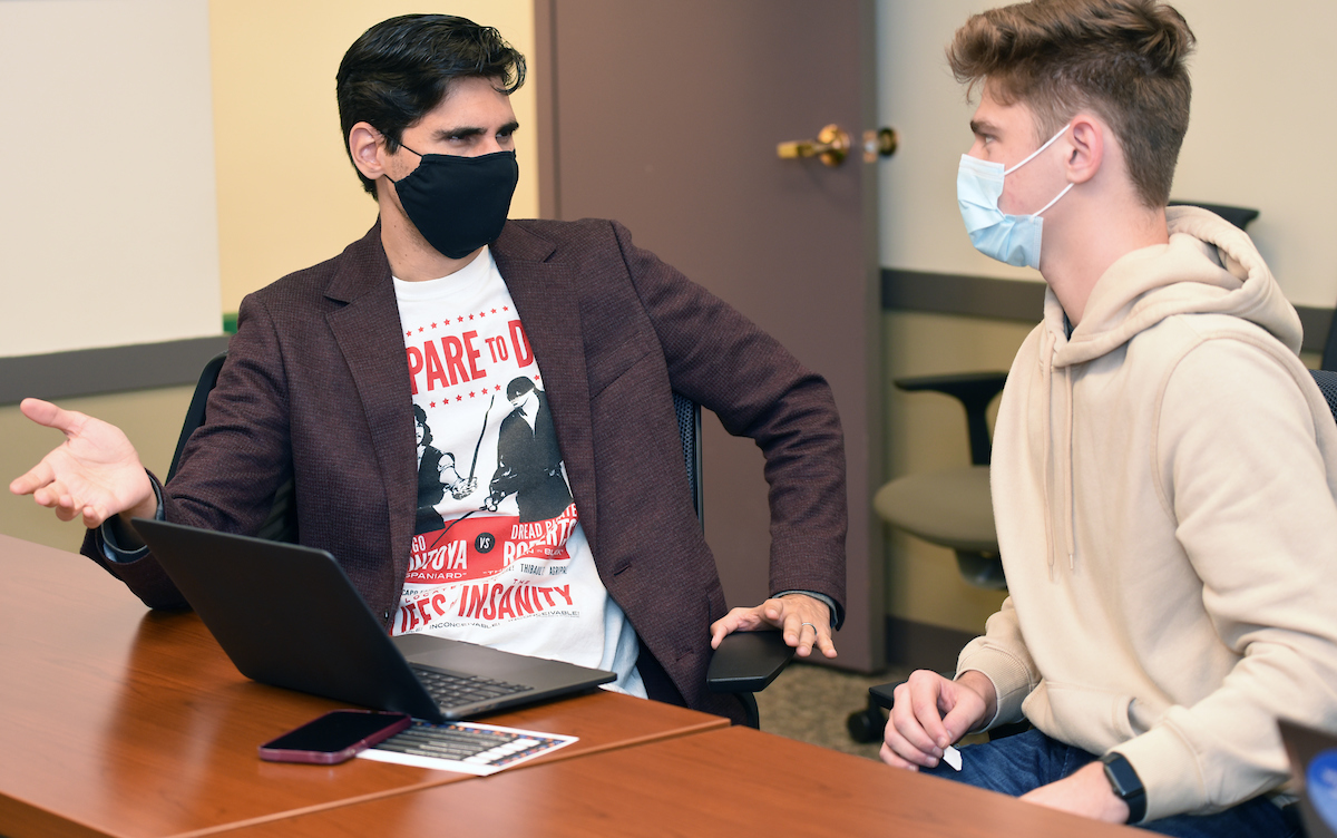 Assistant Professor Ignacio Luri (left) offers résumé tips at this year's Halloween-themed Marketing Careers Tricks and Treats.