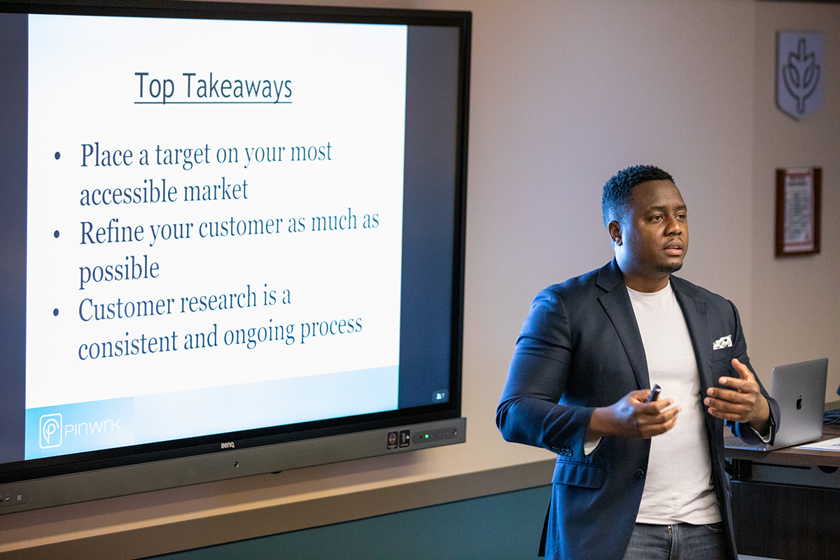 DePaul MBA student Claoe Louis (BUS ’07) presents his business during the final meeting of the Social Impact Incubator Program on Monday, March 7.