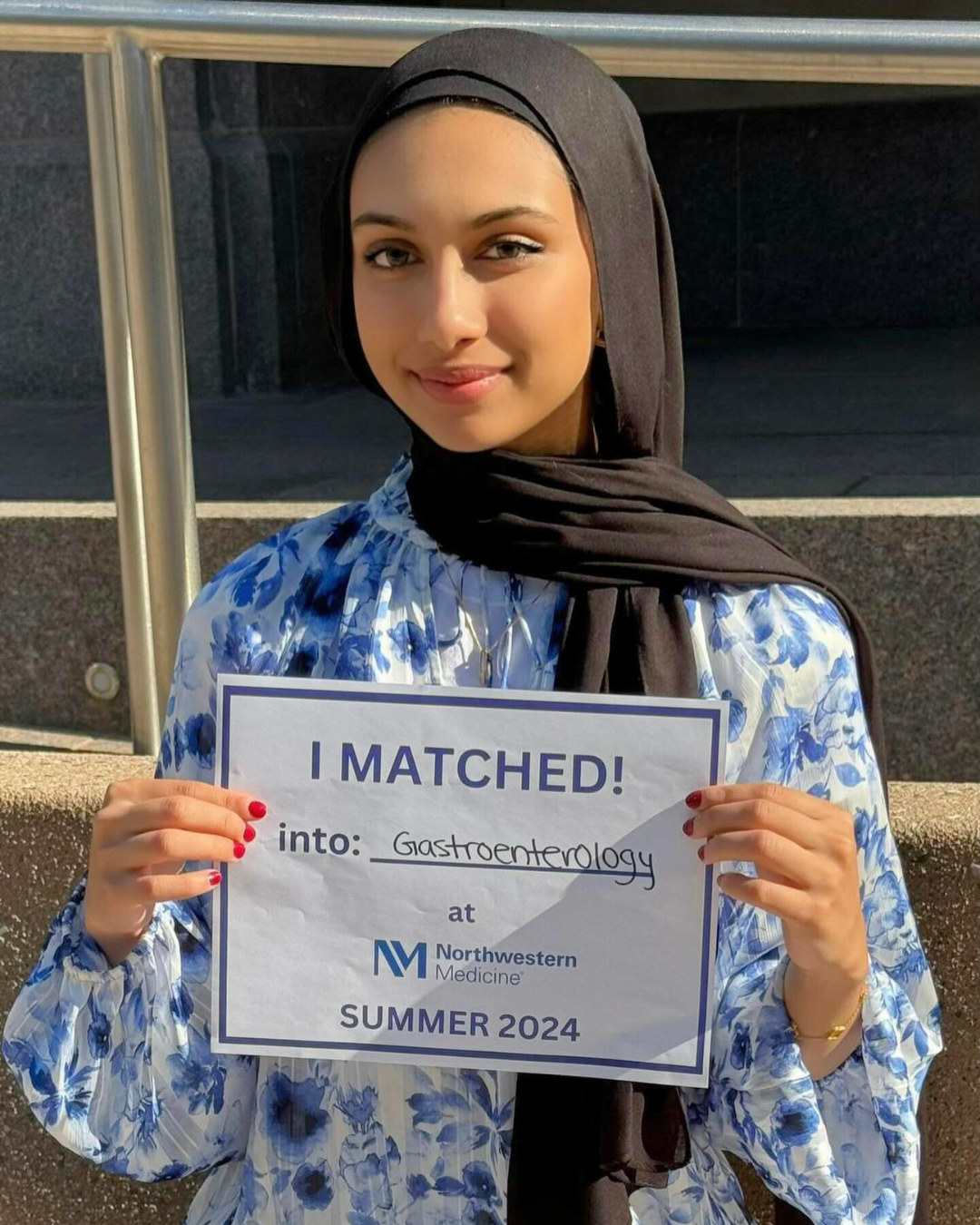 A young woman poses with a certificate reading 